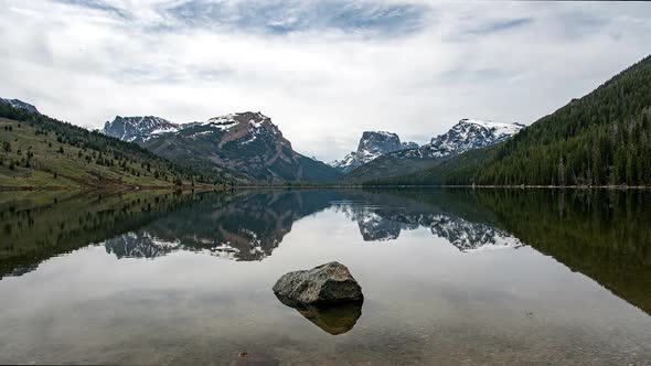 Time lapse of glassy lake viewing reflection of Square Top Mountain alt