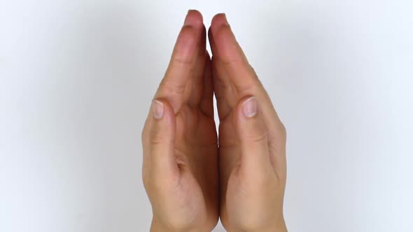 Woman's hands open. A view from above of the palms opening. alt