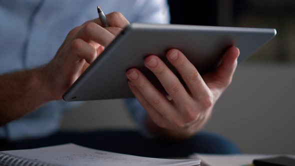 Business Man Researching Tablet Analyze Corporate Data Writing Notes in Office alt