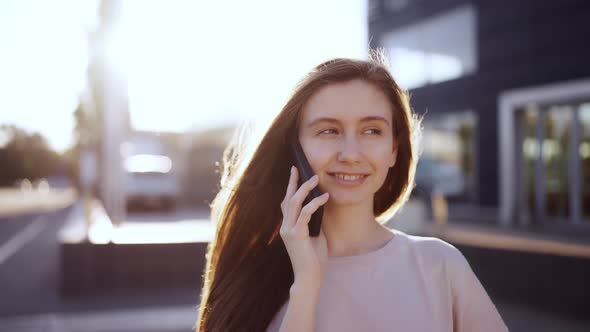 Happy Woman Talking on Mobile Phone Outdoor Lens Flares on Background Slow Motion alt