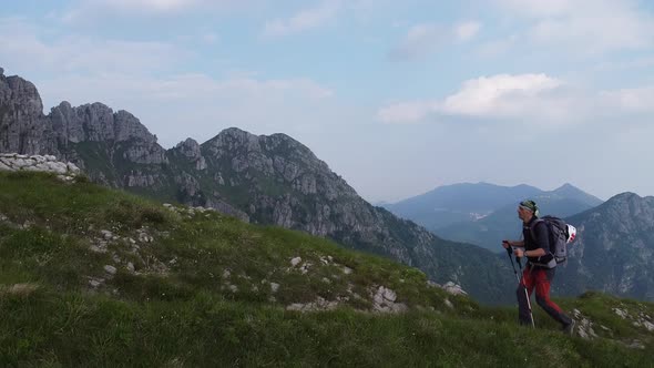 Man trekking on hiking trail, European Alps, Lecco, Italy