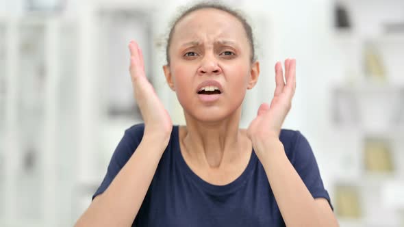 Portrait of Disappointed African Woman Reacting To Loss  alt
