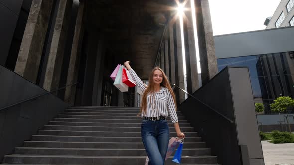 Girl with Shopping Bags, Spining, Dancing, Looking Satisfied with Purchase, Enjoying Price Discounts alt