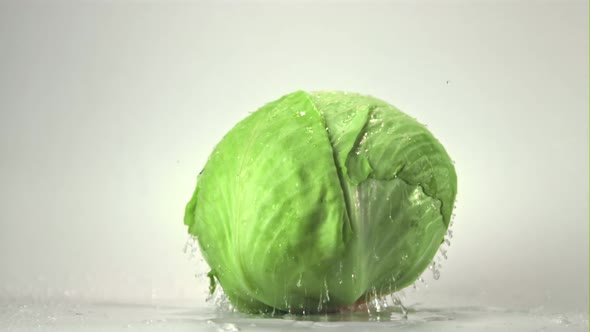 Super Slow Motion of the Fork Cabbage Falls on the Table with Drops of Water alt