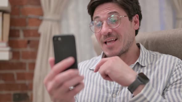 Portrait of Middle Aged Man doing Video Call on Smartphone alt