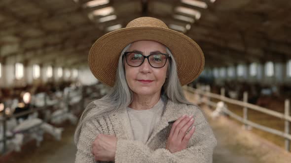 Happy Aged Female Farmer Posing at Goat Ranch alt