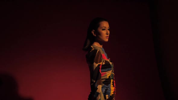 Fashionable Sexy Woman Model of Asian Appearance in a Business Pink Suit alt