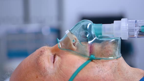 Close Up of Old Man Breathing with Difficulties alt