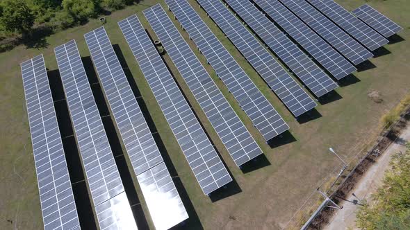 Aerial shot above Solar Panels Farm Field Of Green Renewable Energy. Future development system. alt