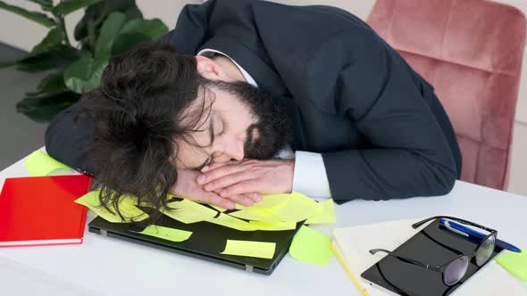 Exhausted and Tired Businessman Sleep with His Head Computer alt