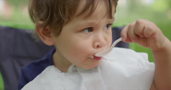 Litte Girl Eating Ice Cream in the Park