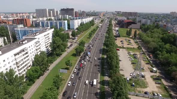 Camera Is Flying Over Road in Modern City in Summer Day