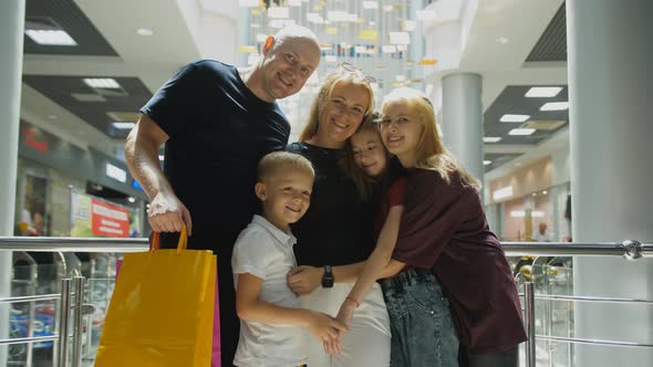 A Happy Family with Three Children in a Shopping Mall