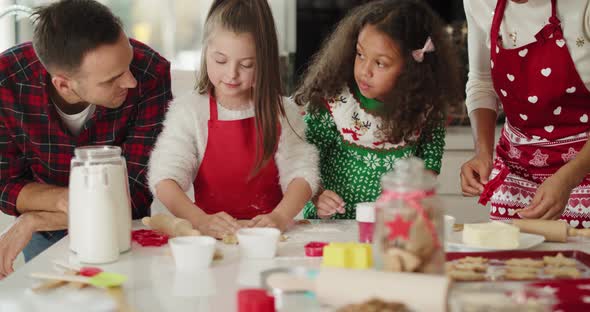 Family preparing christmas cookies in the kitchen alt