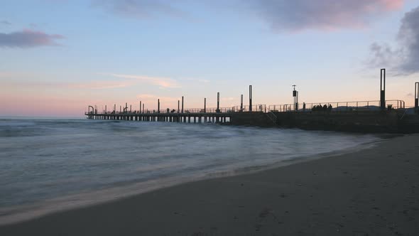 Alassio pier timelapse with people tourist holiday. Mediterranean sea shore coastline in Liguria, tr alt