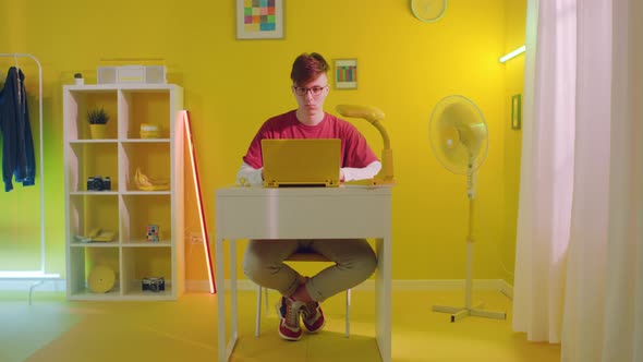 Student Is Calling to Friend On Yellow Laptop