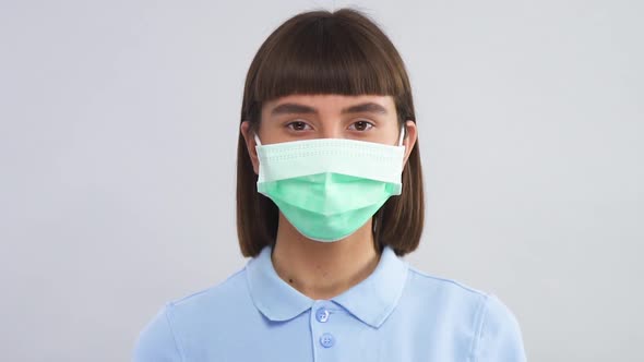 Portrait of Young Female in Protection Mask Looking To Camera and Blinking alt