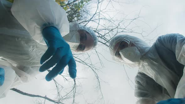 People Wearing Ppe White Suits Showing with Fingers and Arguing alt