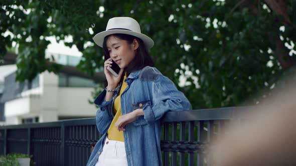 Young beautiful Asian woman talking on the phone.