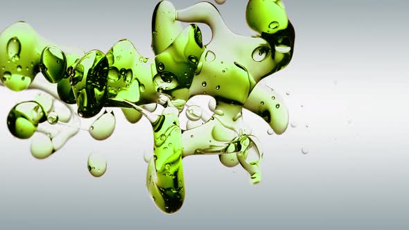 Macro Slow Motion Transparent Cosmetic Green Oil Bubbles and Shapes on white Background
