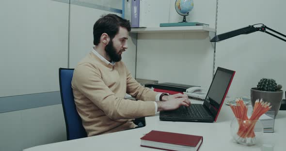 Office Worker, Sitting at His Desk alt