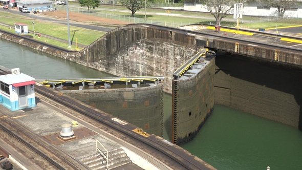A cargo ship passes through the gates of the Panama Canal. alt