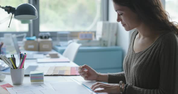 Young creative designer drawing on a house plan