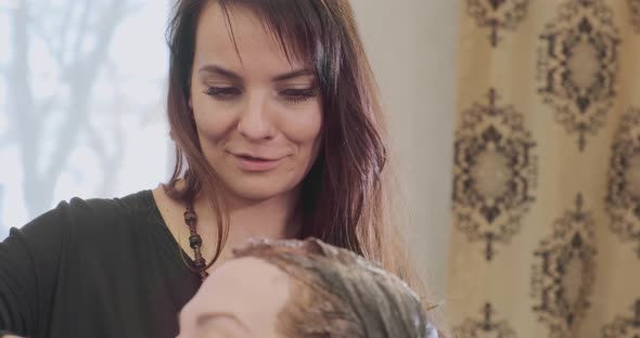 Woman Apply Hair Bleach on Beauty Salon Visitor Head Closeup