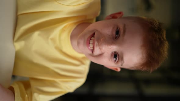 Vertical Closeup Point of View Vlog or Selfie Camera of Cute Cheerful Redhead Child Boy with alt