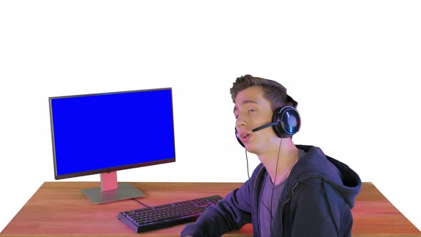 Gamer Talking About the Game on the Screen To Camera on White Background alt