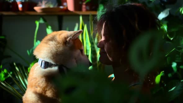 Dog and African Woman Like to Cuddle Among Plant Spbd alt