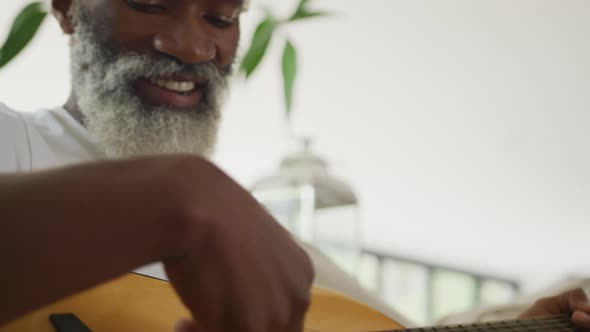Video of sad african american senior man playing the guitar alt