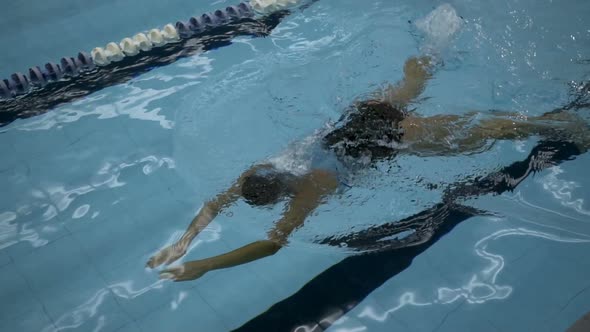 Young Female Swimmer Perfrorming Breaststroke In Swimming Pool, Slow Motion