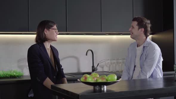 Two Happy Caucasian Gay Men Talking in the Kitchen and Smiling. Portrait of Same Sex Couple Chatting alt