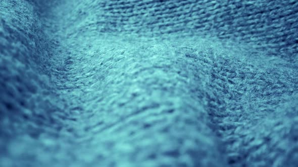 Extreme detail view of sheep wool cloth texture flowing in macro dolly shot. alt
