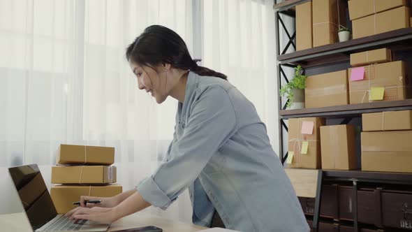 Asian young entrepreneur business owner of SME see business achievement. alt