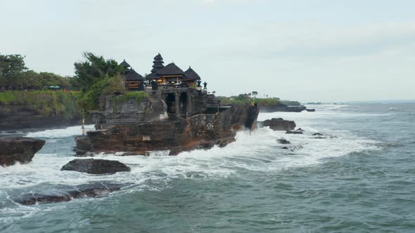 Closing in on Empty Tanah Lot Temple on Dark Dangerous Cliffs in Bali Indonesia alt
