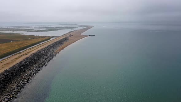 Aerial footage flying on a cloudy cold day in Bournemouth on the South Cliff by the ocean alt