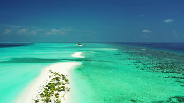 Flying over a sandbanks and uninhabited islands in Turquoise green water in Maldives alt