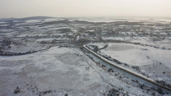 View From a Drone to the Ground Covered with Snow at the Morning alt