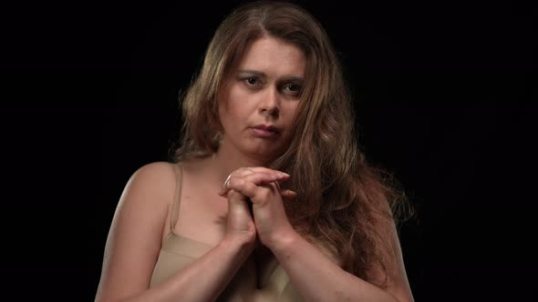 Front View Portrait Sad Depressed Overweight Woman in Bra Holding Hands Together Looking at Camera alt