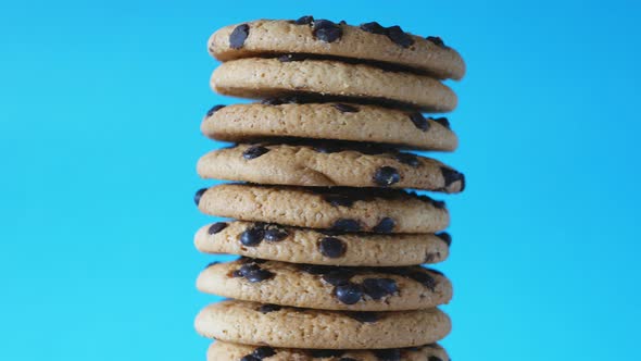 A Stack Chocolate Chip Cookies Rotate on a Blue Background alt