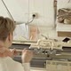 Back view of woman works behind a knitting machine - VideoHive Item for Sale