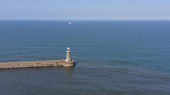 A Lighthouse and Breakwater at the Mouth of a Harbour in the UK alt