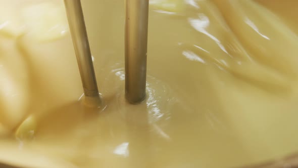 Mixing ingredients for chocolate fudge at candy factory