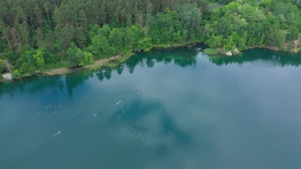 Aerial View People Swim On The Lake alt