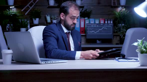 Young Businessman Working Long Hours in Night alt