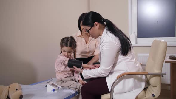 Family Doctor Measuring Pressure of Child Patient alt
