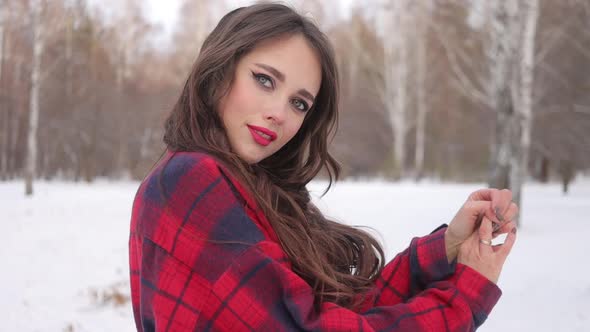 Woman with Red Lips in Winter Forest