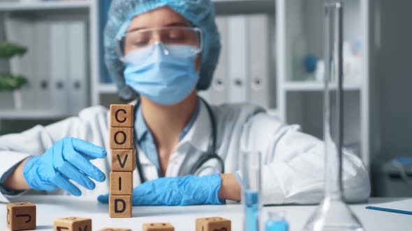 The Word Covid Collapses Crashes Falls Disappears. The Laboratory Doctor alt